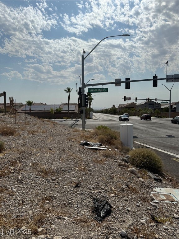 View of asphalt street with traffic lights and str