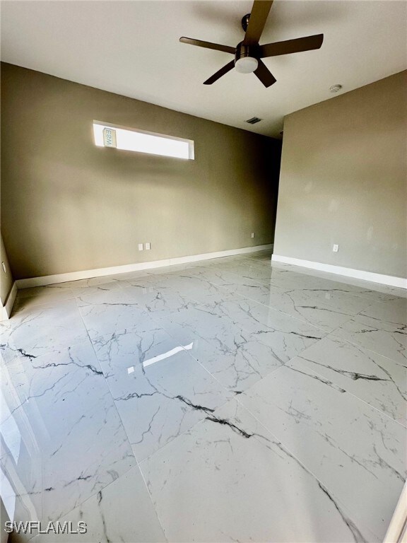 Unfurnished room featuring ceiling fan