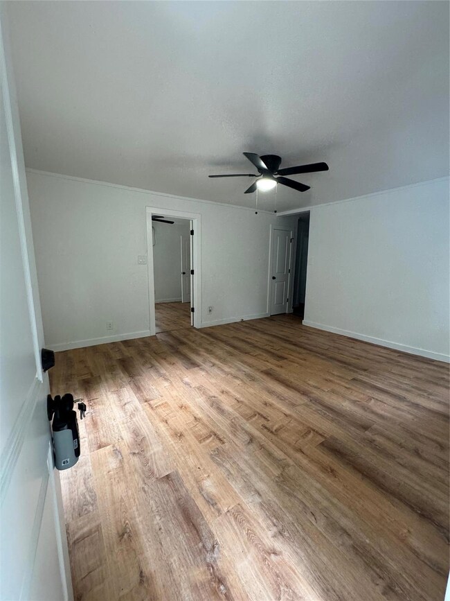 Big Living Room with light hardwood / wood-style f