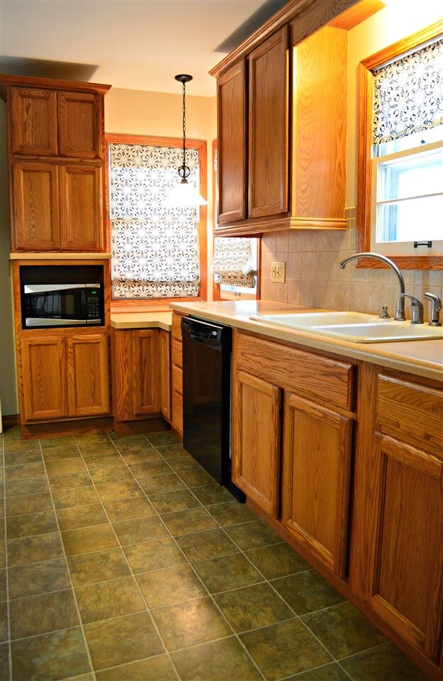 Updated kitchen with tile. All appliances stay wit