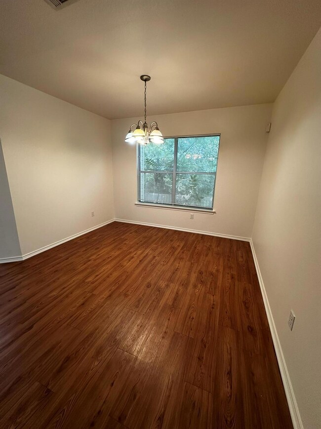 Unfurnished room featuring dark wood-type floorin