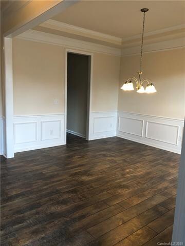 Formal dining room with tray ceiling and walk thro