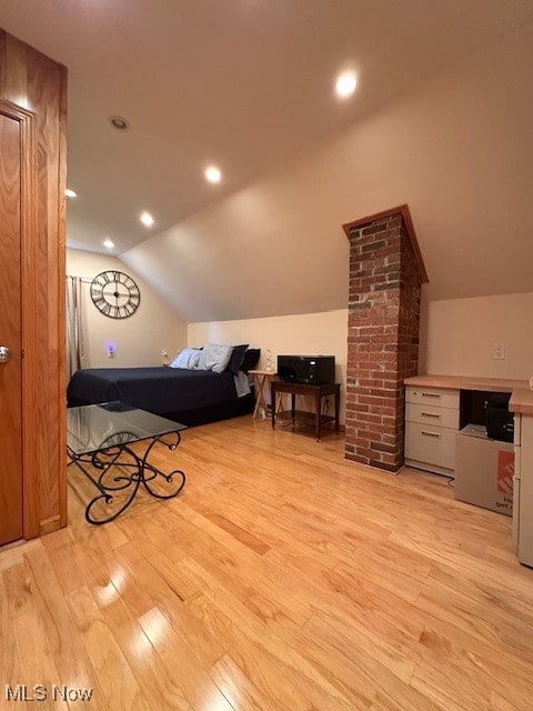 Bedroom with vaulted ceiling, recessed lighting, and light wood finished floors