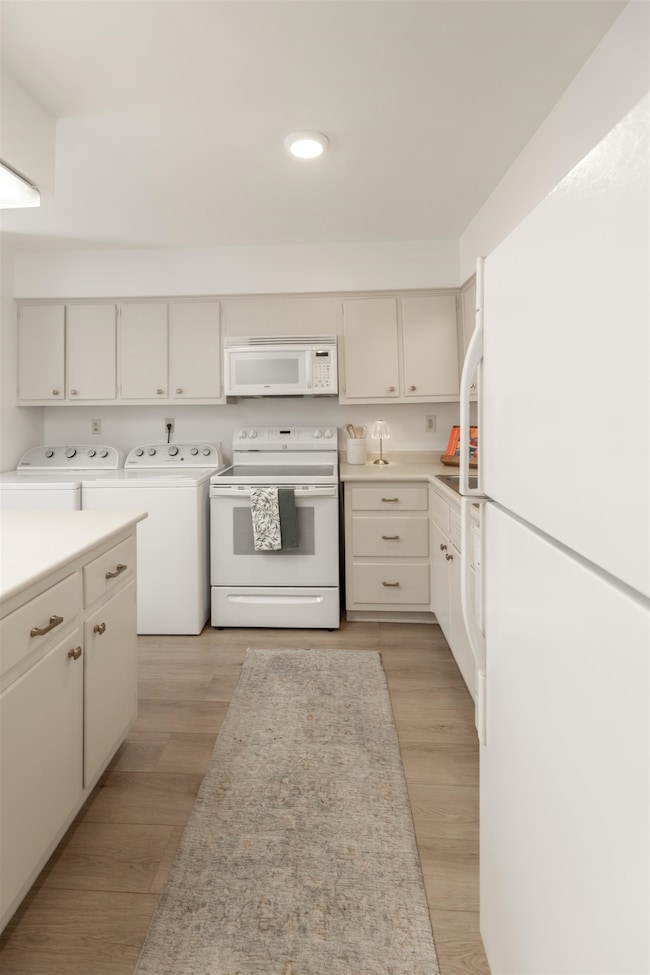 Kitchen featuring neutral cabinets, light wood-typ