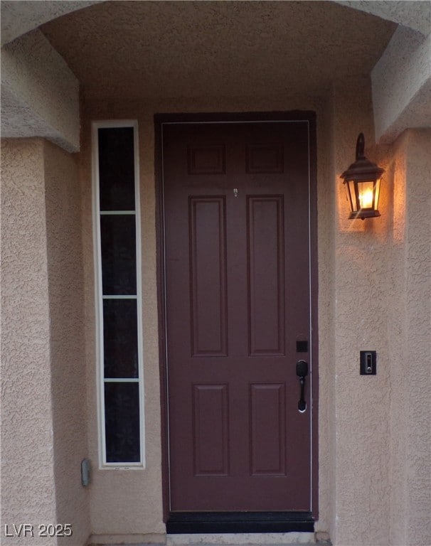 Property entrance featuring stucco siding