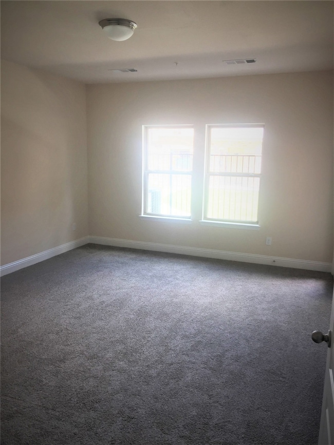 Spare room with carpet flooring and baseboards