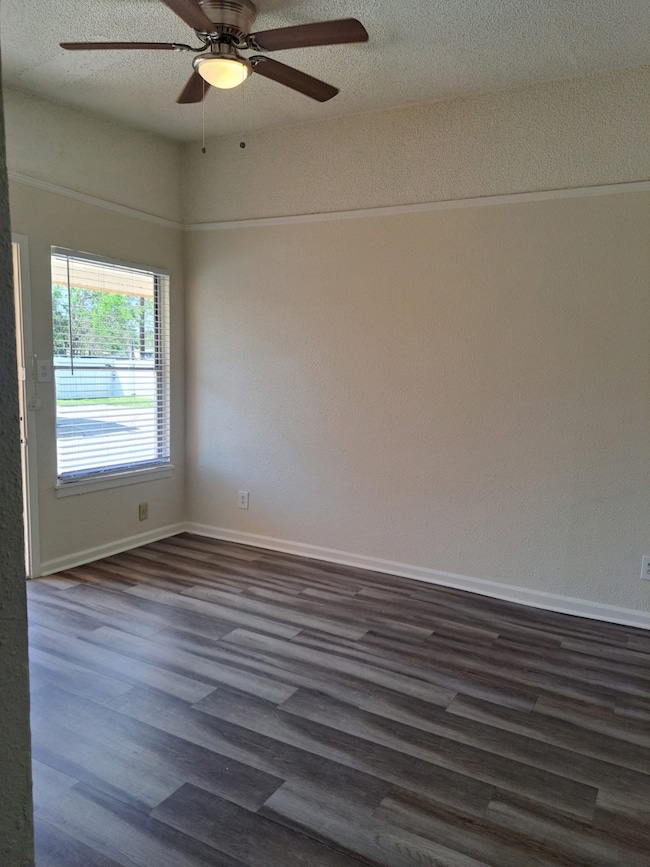 Living area with ceiling fan and no carpet, light