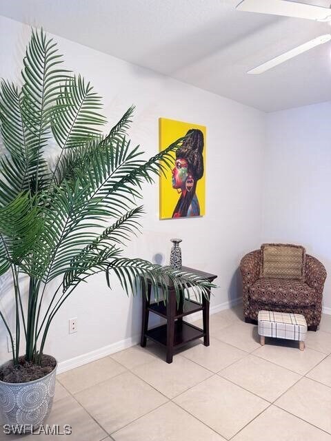 Living area with light tile patterned floors and b