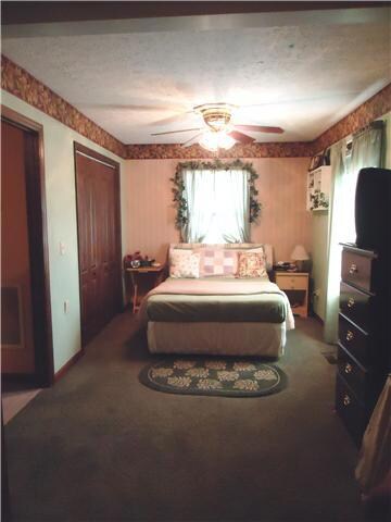 The master suite has his/her closets with one in the bedroom and one in the bath. Sunny windows, ceiling fan lighting and full bath make this room serene.