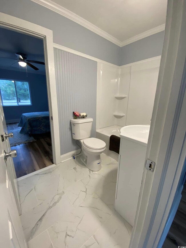 Full bathroom featuring ornamental molding, vanity