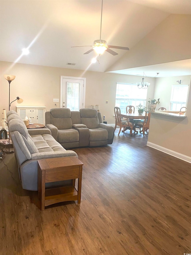 Living room featuring dark wood-style floors, visi