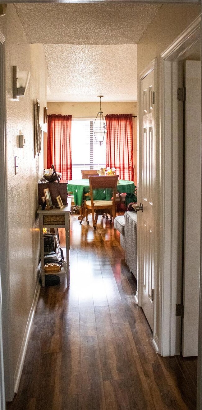 Hallway featuring dark wood flooring