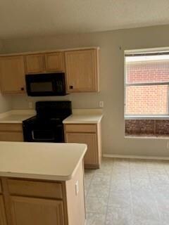 Kitchen with light tile floors and stove