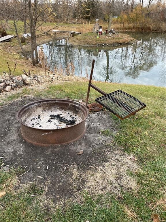 Firepit next to the pond and campsite hookups