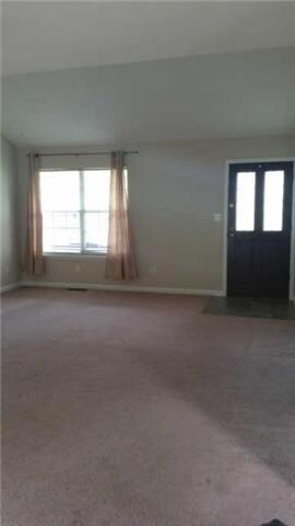 Abundant light throughout. The living room features vaulted ceilings and a serene view.