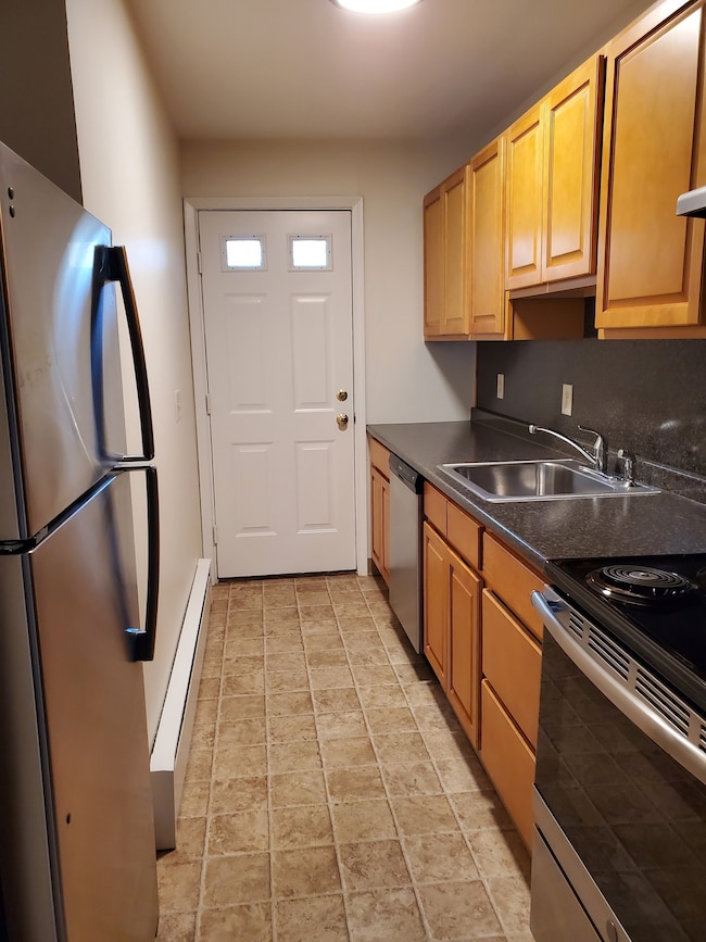 Kitchen has electric oven/range, stainless refridgerator and dishwasher.