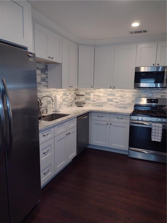KITCHEN WITH STAINLESS APPLIANCES AND MARBLE COUNT
