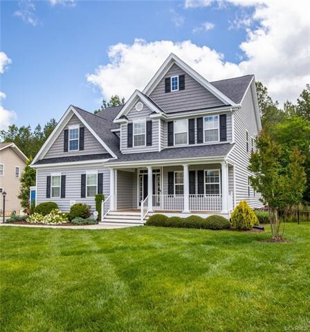 Front of home with beautiful lawn with irrigation.