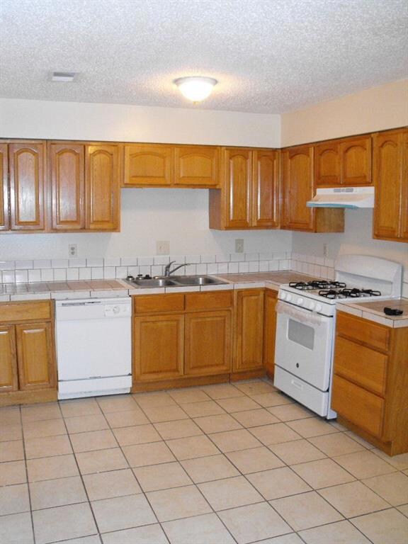 Kitchen featuring new range and vent hood.