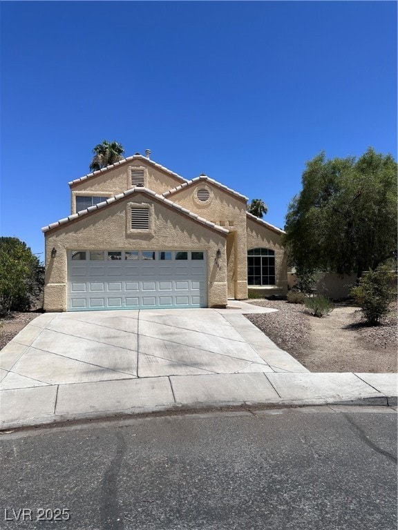 Mediterranean / spanish home featuring driveway, s