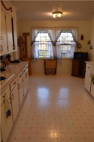 Eat in kitchen with plenty of cabinets and newer dishwasher and oven.