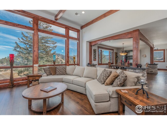 Open floor plan with vaulted, beamed ceilings