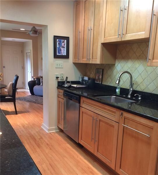 kitchen has Stainless steel appliances, tiled back