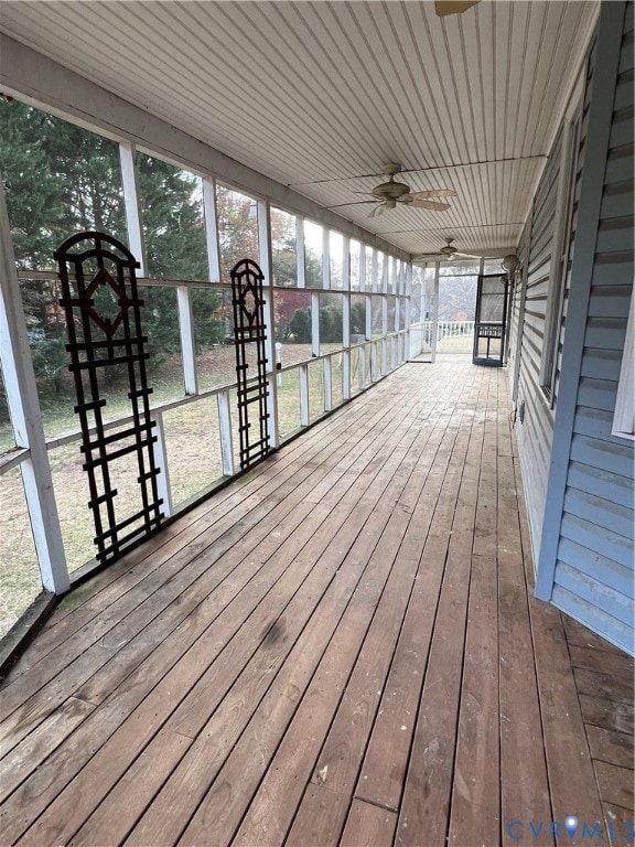 Screened wrap around porch featuring ceiling fan