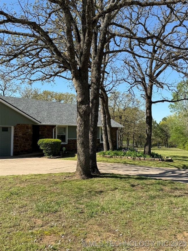 View of front of home featuring concrete driveway,