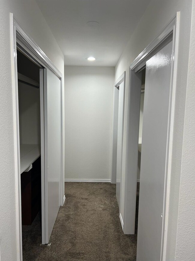 Hallway with dark carpet