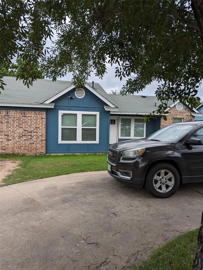 Single story home featuring brick siding, a front