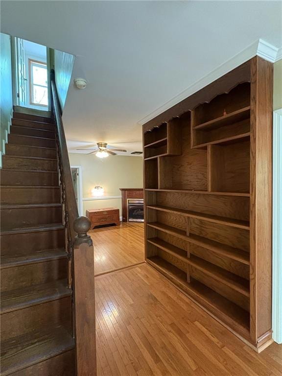 Stairway featuring a fireplace, hardwood / wood-st