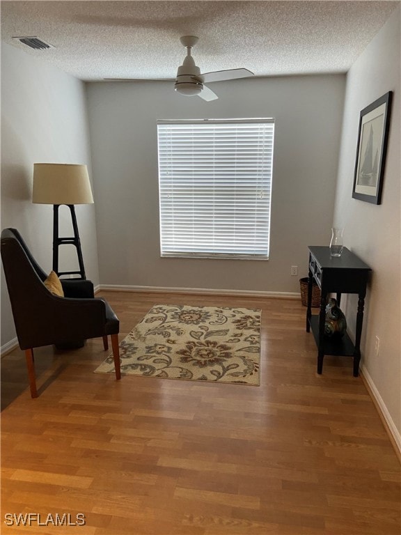 Sitting room with visible vents, light wood-style