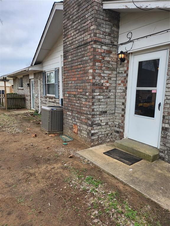 View of exterior entry with central AC unit and br