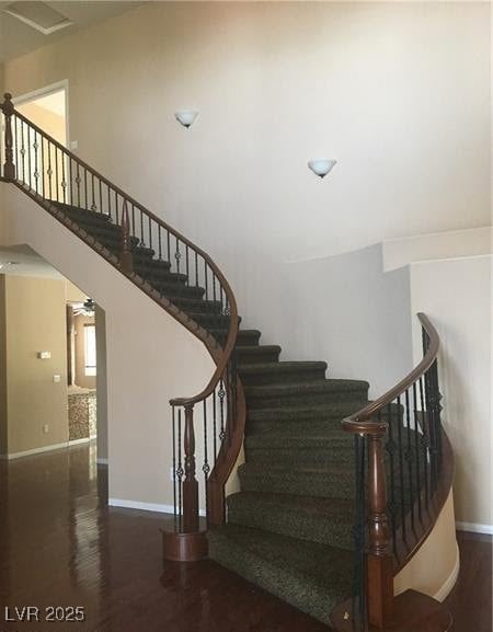 Stairway featuring wood finished floors and baseboards