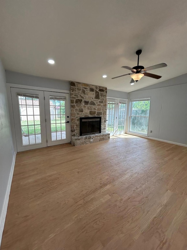 Unfurnished living room featuring wood finished f