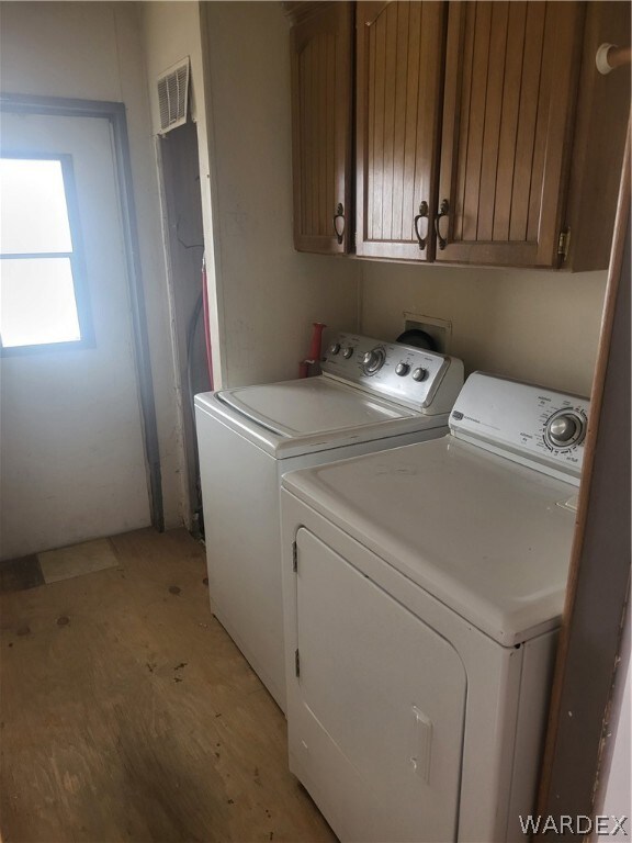 Laundry area with cabinets and separate washer and