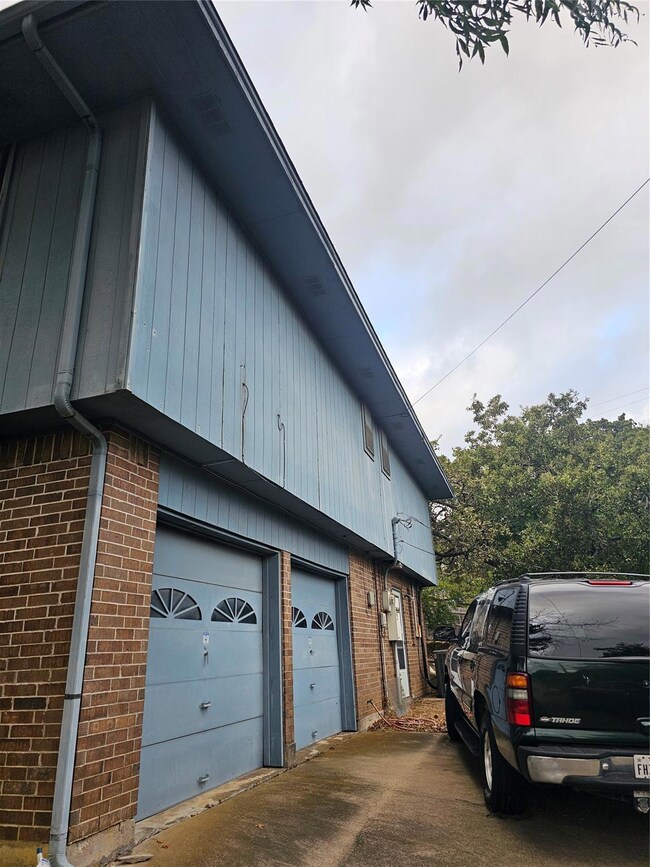View of property exterior featuring a garage