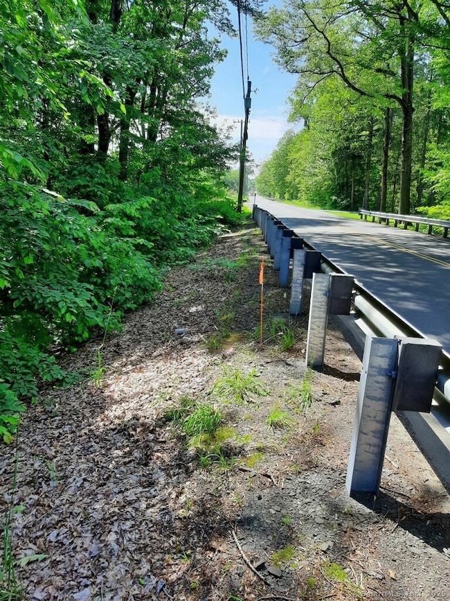 5.93 acre parcel has a guardrail across the entire piece. See signs.