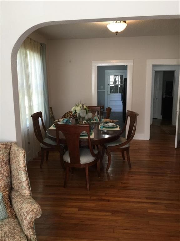 Dining area featuring baseboards, wood finished fl