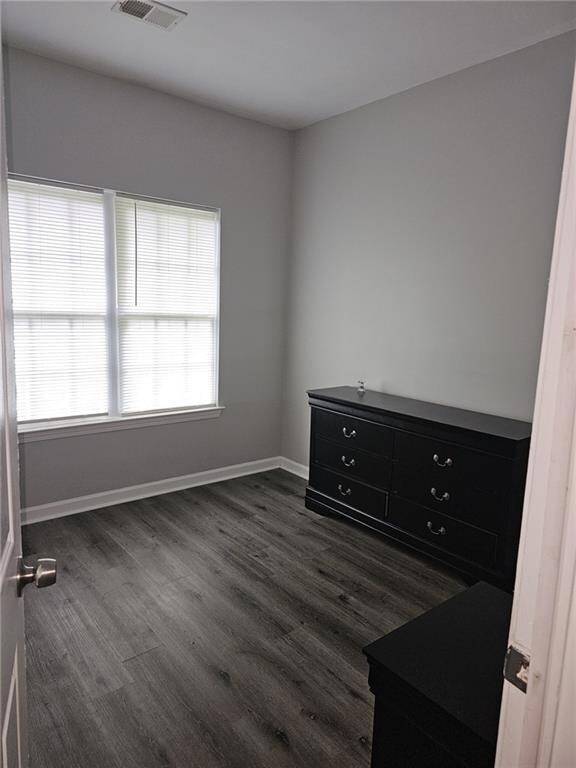 Empty room featuring dark wood-style floors