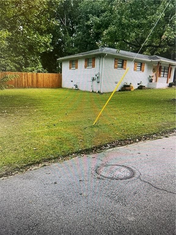 View of front of house featuring brick siding, view of scattered trees, and a porch