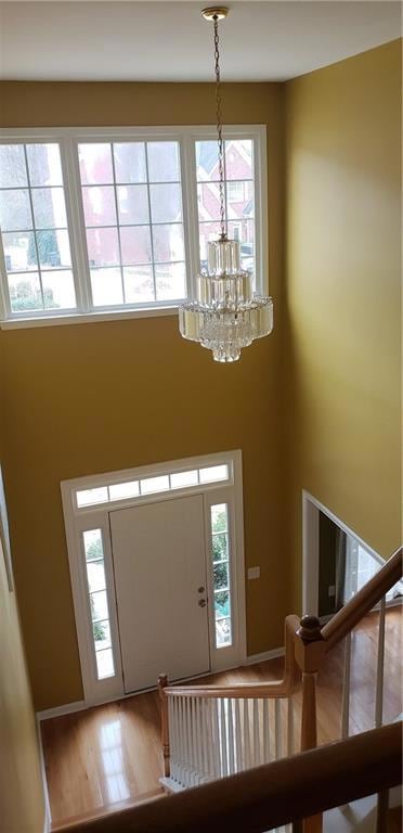 Foyer entrance with an inviting chandelier, a high
