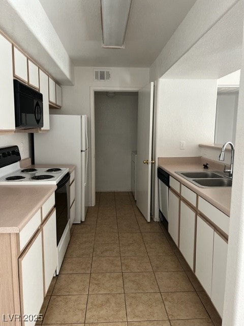 Kitchen with visible vents, dishwasher, a sink, li