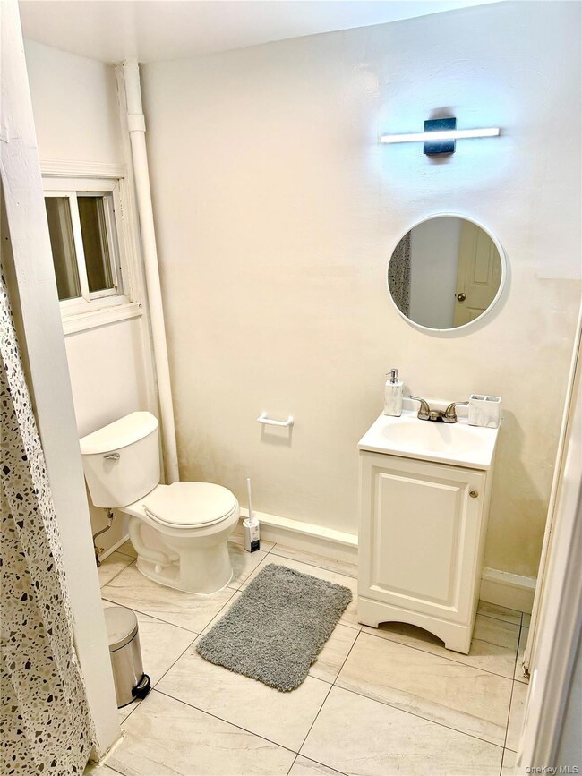 Bathroom with vanity and light tile patterned flooring