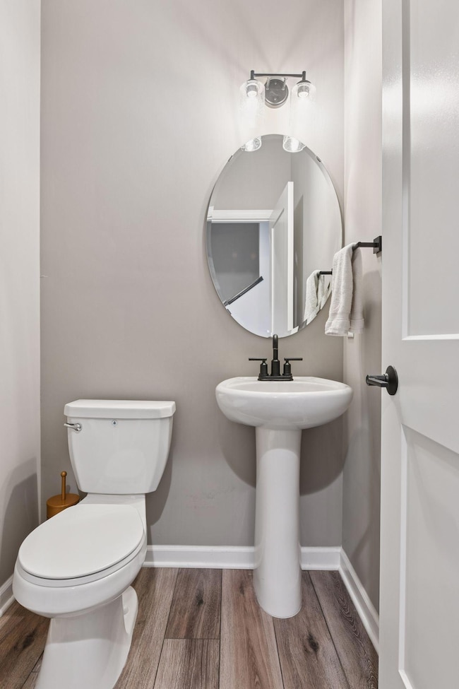 The Powder Room is located just off the foyer.