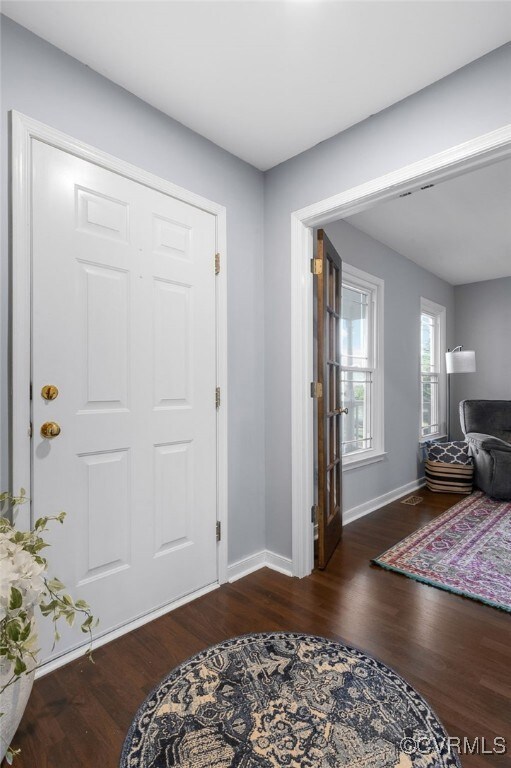 Foyer with wood finished floors and baseboards