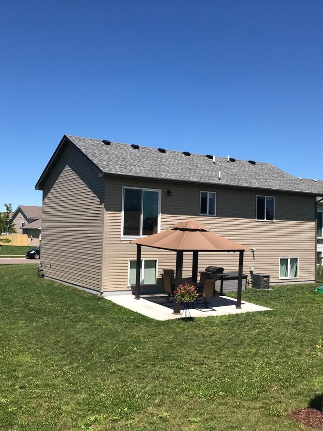 Partially fenced rear yard with gazebo on concrete