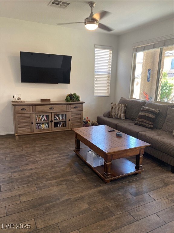 Living room with dark wood-style flooring, ceiling