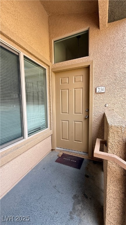 Entrance to property featuring stucco siding